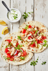 Grilled chicken and fresh  vegetables salad  tortilla .Healthy delicious breakfast or snack , top view. Flat lay.Outdoors Food Concept