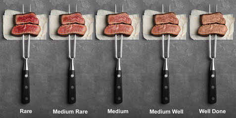 Delicious sliced beef tenderloins with different degrees of doneness on grey background, top view....