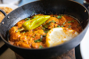 Indian Curry food photography close up - Balti curry, Chicken and chilli hot and spicy with lime and garnish