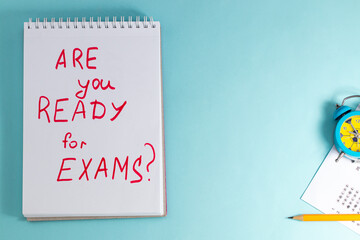 Notebook with question "Are you ready for exams?" on blue background, top view copy space