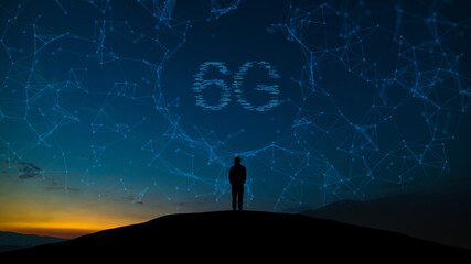 The man stands on the mountain top on the 6g holographic network background