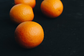 Oranges on black textured background.