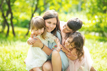 Happy beautiful family together mother and children walk on a Sunny summer day