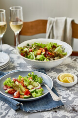 Healthy vegetable salad of fresh tomato, cucumber, pepper,  onion, lettuce and olive oil   on plate. Diet menu
