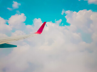 Plane window view - View of beautiful clouds and wing of airplane from window