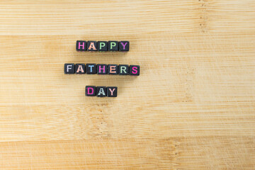 Happy Fathers Day blocks on a rustic wood background