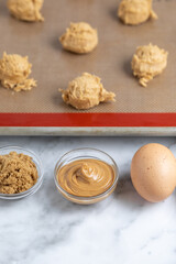 Dish of peanut butter beside cookie ingredients, with space for text