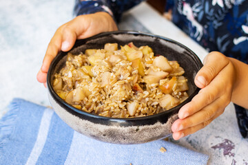 Whole oats granola porridge with fruits - apples and peaches. Vegan breakfast food.