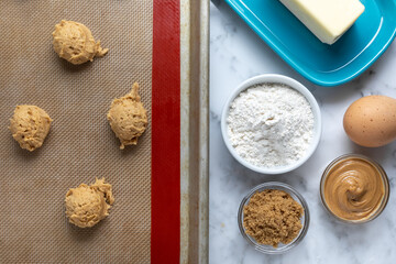 Top down view on peanut butter cookies beside baking ingredients