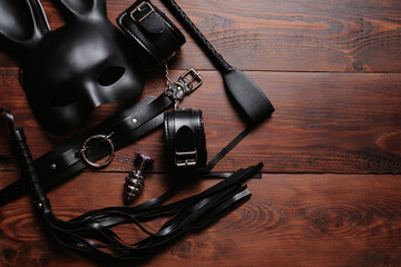 set of sex toys for hard BDSM sex with domination and submission. Leather whip, handcuffs, belt