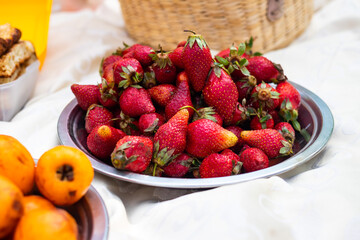 Ripe red strawberry on a picnic blanket for breakfast