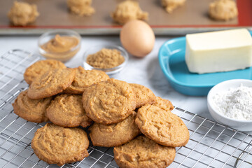 Baked cookies with recipe ingredients in the background