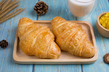 freshly croissants on wooden plate
