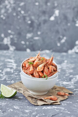 Boiled shrimps on a white bowl with lime 
