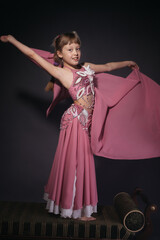 A little girl dressed as an belly dancer