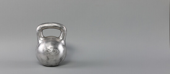silver sports kettlebell isolated on gray background