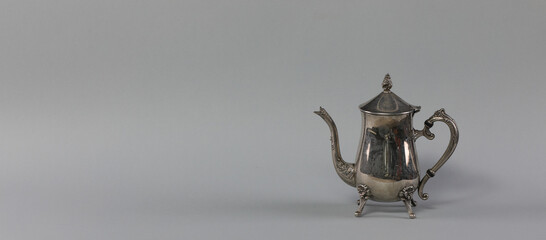 Fototapeta na wymiar silver arabic teapot isolated on gray background
