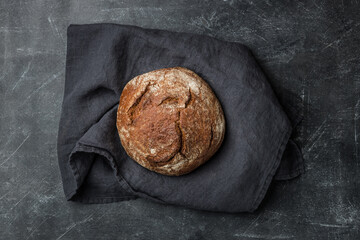 Rustic bread on dark background. Flat lay.