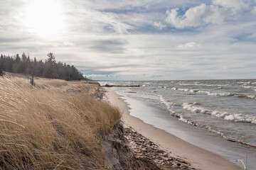 Scenic of the waves of Lake Huron overtaking the beach at high tide in Grand Bend Ontario in Deecember