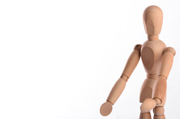 Wooden figure mannequin posing in action isolated on white background.