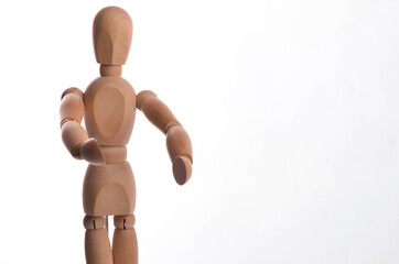 Wooden figure mannequin posing in action isolated on white background.