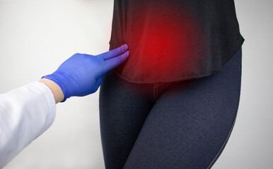A woman suffers from pain in the pelvic organs. The gynecologist examines the patient. Painful...