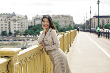 Fototapeta premium Elegant woman is walking in the city