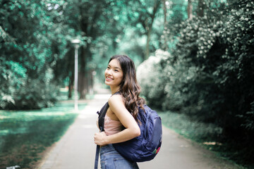 Obraz premium Asian girl is walking in a park