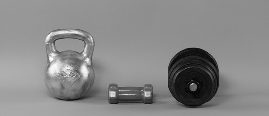 sport kettlebell and dumbbell isolated on gray background