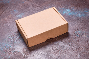 Single brown cardboard box on dark background
