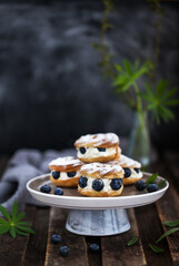 Cream puff rings (choux pastry) decorated with fresh blueberries