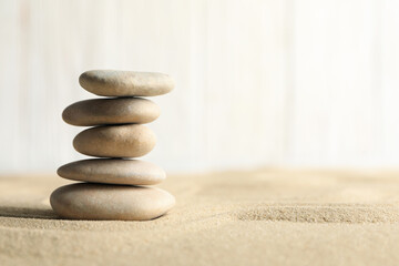 Fototapeta na wymiar Stones on the sand background. Zen concept