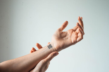 hand of a young woman with gr code. Identification, advanced technologies, population database for control.