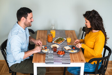 Happy couple eating breakfast together stock photo