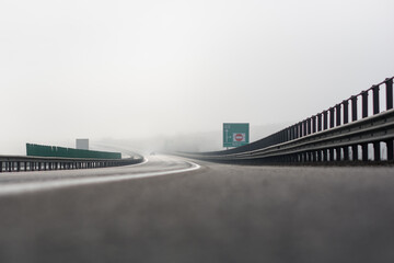 Highway with two lanes in each direction, for domestic cars in foggy conditions