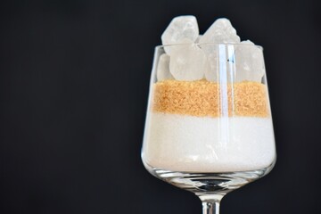 glass containing various types of sugar to demonstrate how much is contained in alcoholic drinks 