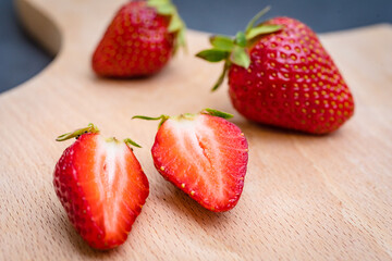 Fresh ripe delicious strawberries on wooden board.