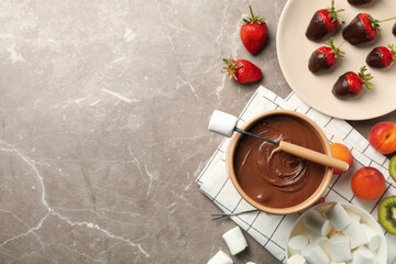 Composition with ingredients for chocolate fondue on gray table. Cooking fondue