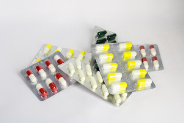 Multi-colored pills on a white background