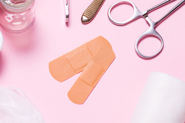 Set of adhesive bandage, medical sticking plaster on pink background