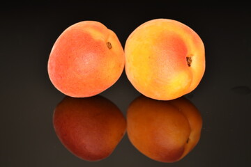 Ripe sweet, organic apricots, close-up, on a black background.