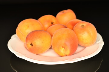 Ripe sweet, organic apricots, close-up, on a black background.