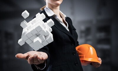 Businesswoman holds in palm abstract 3d cube