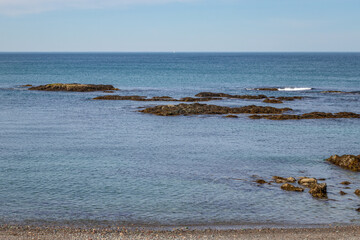 seascape of rocky beach with horizon in background