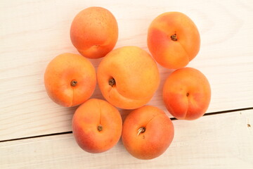 Ripe sweet, organic apricots, close-up, on a painted wooden table