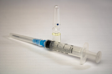 Syringe with injection with ampoule
