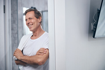 Smiling fit man standing in the doorway