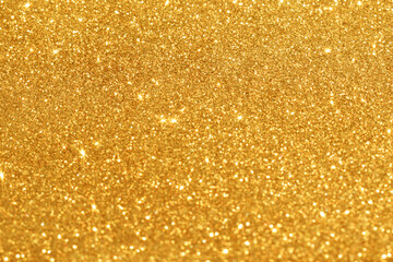 Golden blurred bokeh glitter background.