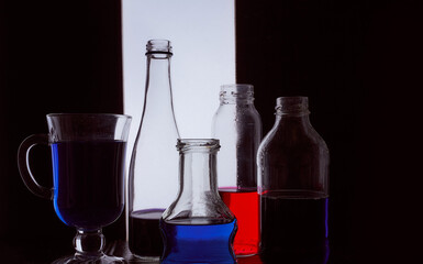 bottled on a light background with blue and red liquid silhouette photo