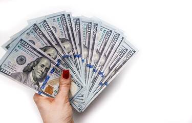 Hundred dollar bills in a woman's hand on a white background. Space for text